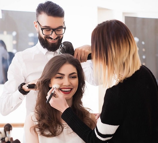 woman having makeup and hair done